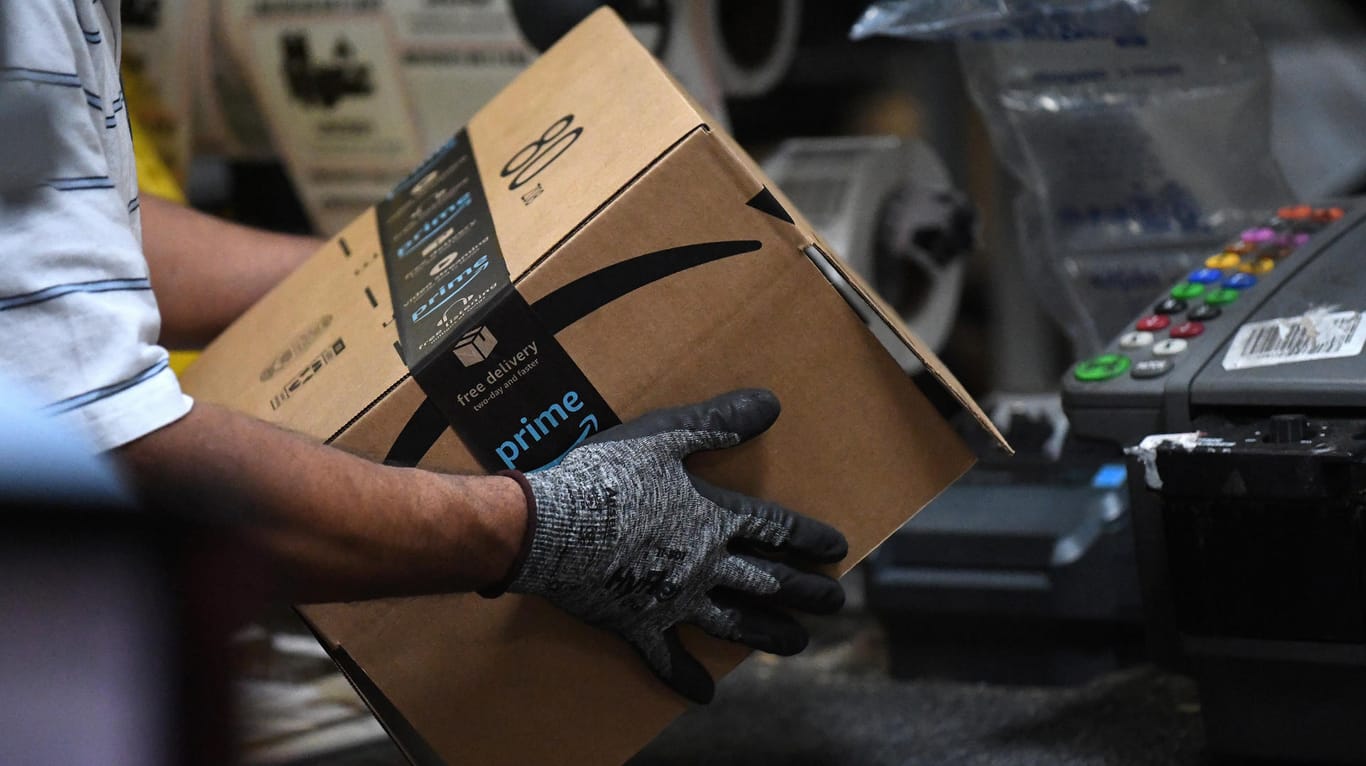 Ein Amazon-Mitarbeiter hält ein versandfertiges Paket: In der Woche vor dem "Black Friday" geht es bei dem Online-Versandhändler hoch her.