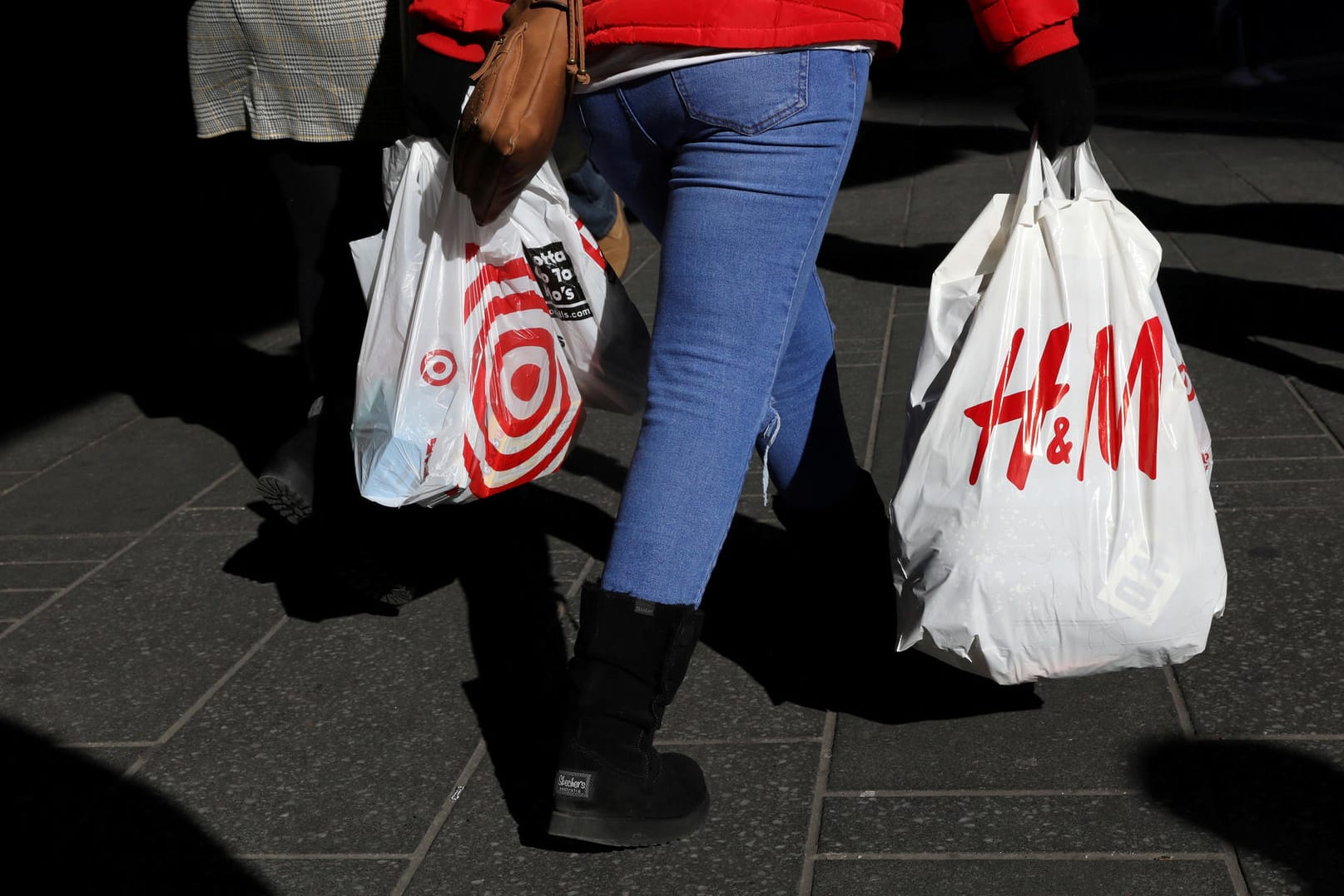 Eine Frau mit Einkaufstüten läuft über die Straße: Vor dem US-Feiertag Thanksgiving locken viele Händler am sogenannten "Black Friday" mit Sonderangeboten.