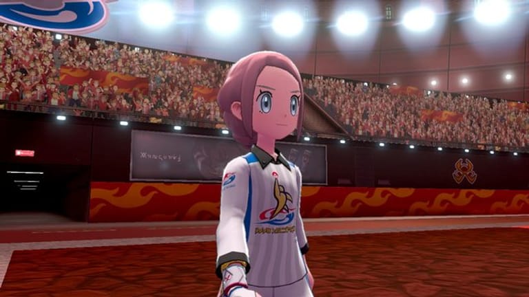Eine Pokémon-Trainerin betritt unter Fan-Jubel die Arena.