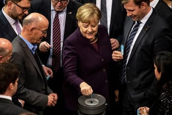 Kanzlerin Angela Merkel und Abgeordnete bei der Abstimmung im Bundestag.