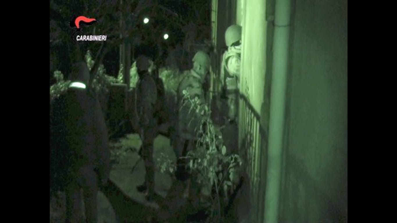 Schwer bewaffnete Polizisten dringen in ein Gebäude in der Gegend um Vibo Valentinia ein.