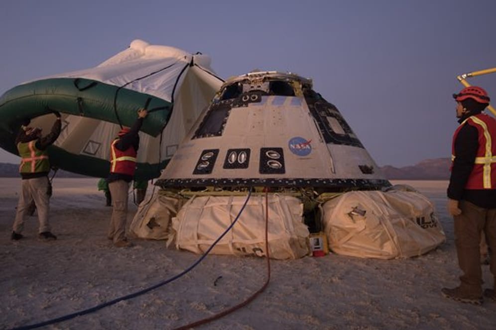 Mitarbeiter von Boeing, NASA und der US-Armee inspizieren die "Starliner"-Kapsel nach deren Landung in der Wüste von New Mexico.