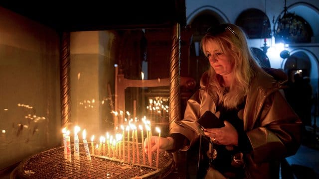 Weihnachten in Bethlehem: Eine Besucherin zündet eine Kerze in der Geburtskirche an. Weihnachten in Bethlehem: Eine Besucherin zündet eine Kerze in der Geburtskirche an.