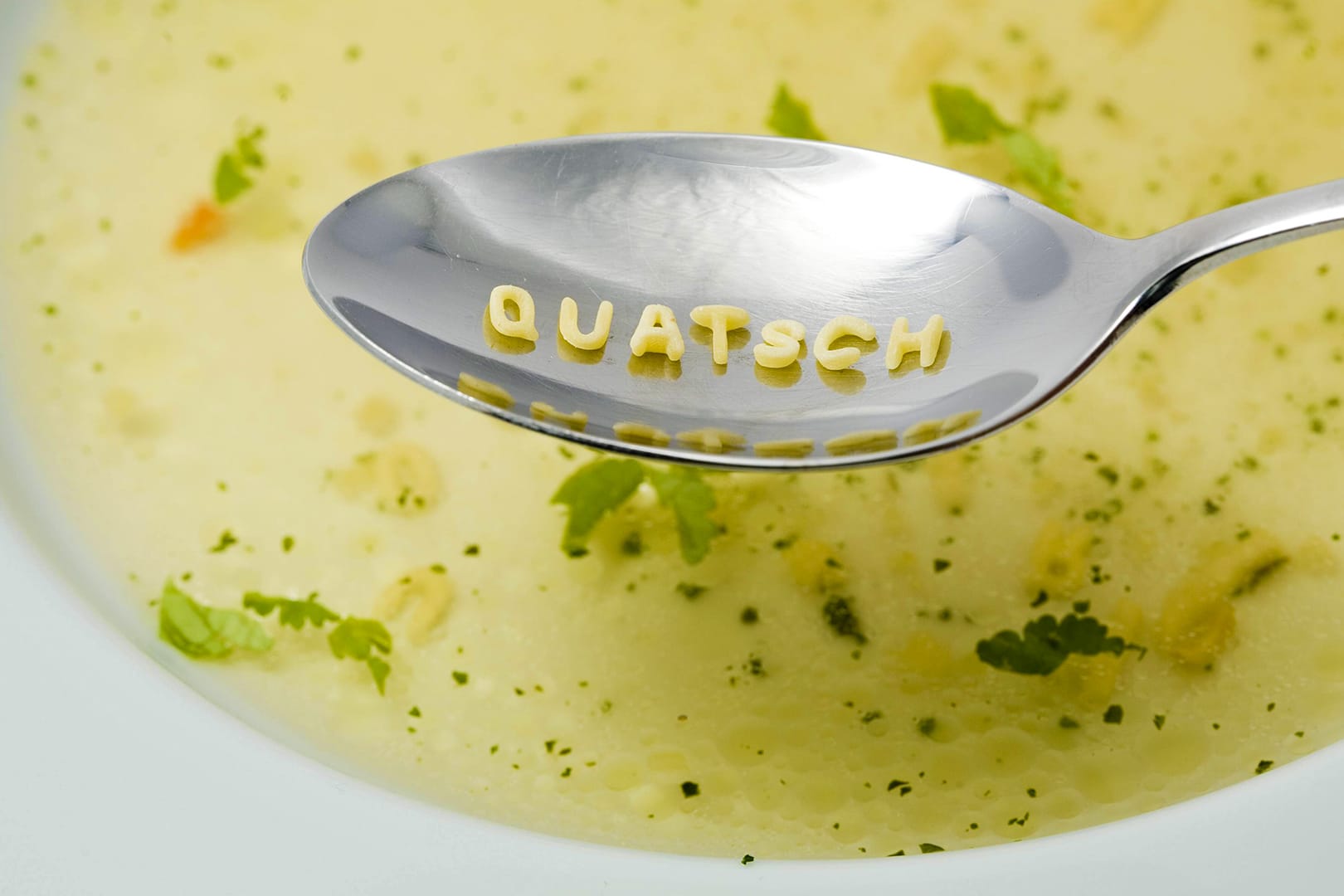 Quatsch – gelegt aus Buchstaben einer Buchstabensuppe auf einem Löffel: Redewendungen werden gerne mal verdreht, was häufig zu komischen Bedeutungsänderungen kommt.