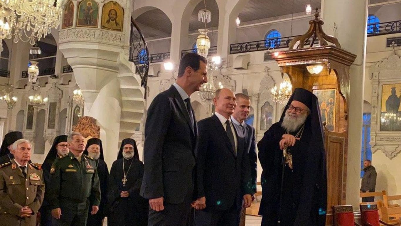 Besichtigungstour durch Damaskus: In der Mariamitischen Kathedrale werden Putin und Assad von einem Geistlichen empfangen.