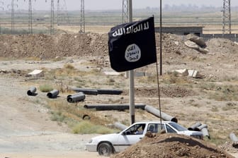 Die Flagge des IS an einer Straße im Irak (Symbolbild): Die Terrormiliz hat weiterhin viele Schläferzellen und Funktionäre, die versteckt leben.