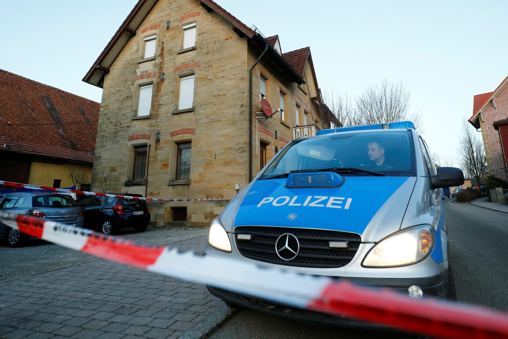 Polizeiwagen und Absperrband am Tatort in Rot am See: "Ich kann das noch gar nicht glauben".