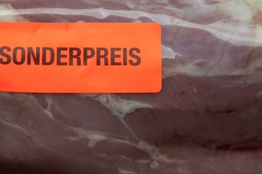 Ein Aufkleber mit der Aufschrift "Sonderpreis" klebt auf einem Stück Schweinefleisch.