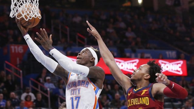 Dennis Schröder (l) von Oklahoma City Thunder setzt sich am Korb gegen Darius Garland von den Cleveland Cavaliers durch. Dennis Schröder (l) von Oklahoma City Thunder setzt sich am Korb gegen Darius Garland von den Cleveland Cavaliers durch.