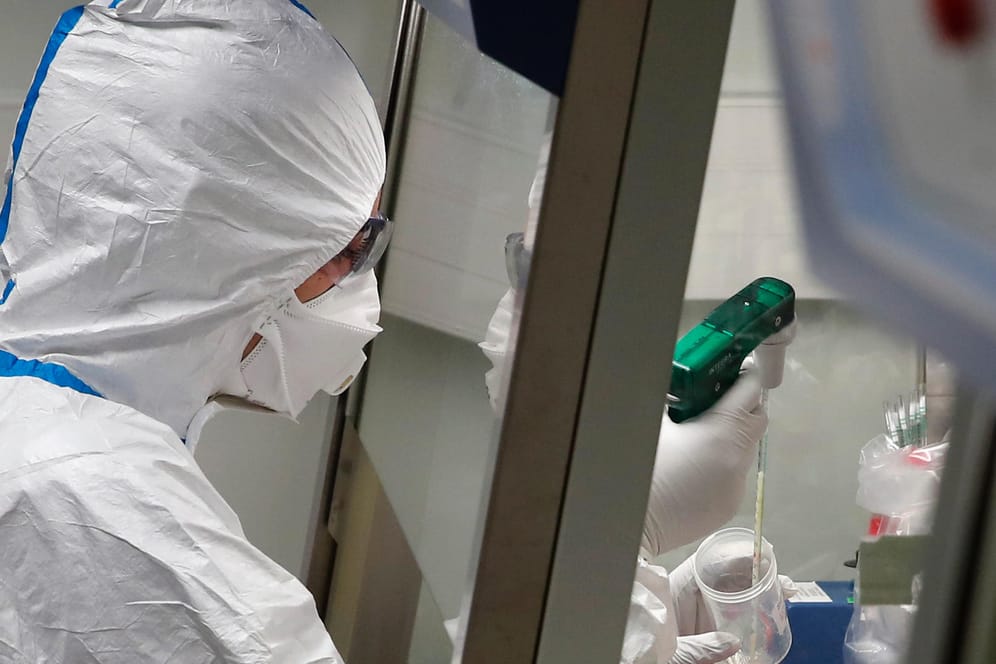 Paris: Ein Laborwissenschaftler in Schutzkleidung arbeitet im Institut Pasteur mit Proben von Patienten, die mit dem Coronavirus infiziert sind.