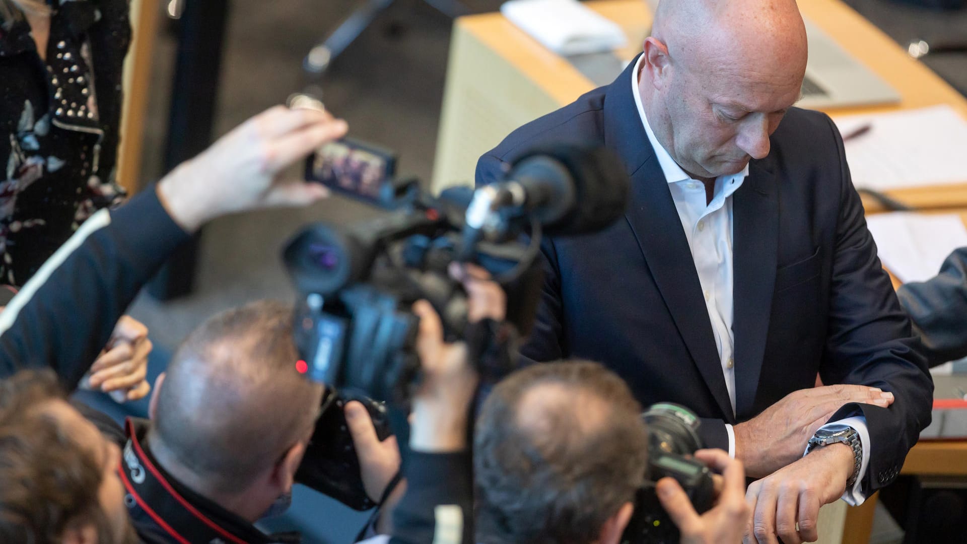 Thomas Kemmerich, Thüringens neu gewählter Ministerpräsident, blickt im Thüringer Landtag auf die Uhr.