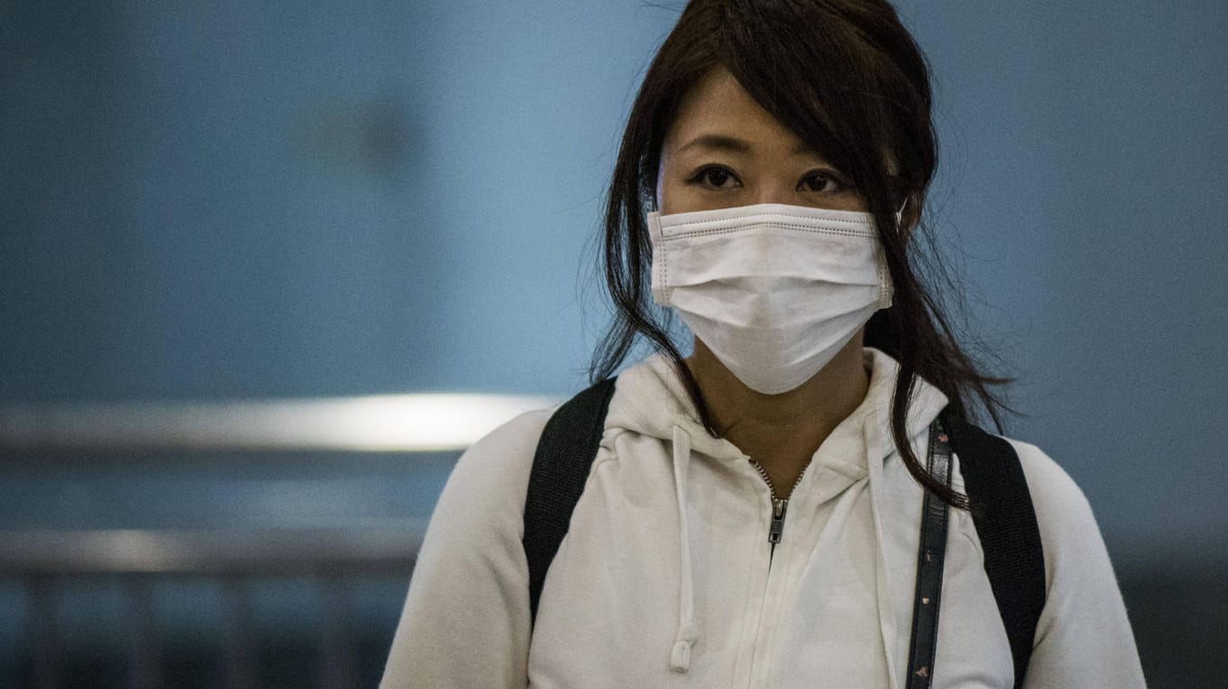 Eine junge Asiatin will sich mit einer Atemschutzmaske vor einer Coronavirus-Infektion schützen: Sie ist keine Chinesin!