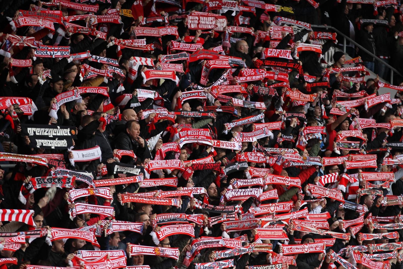 Fans von Rot-Weiß Erfurt halten ihren Schal hoch: Die Profi-Mannschaft musste wegen der Pleite vom Spielbetrieb abgemeldet werden.