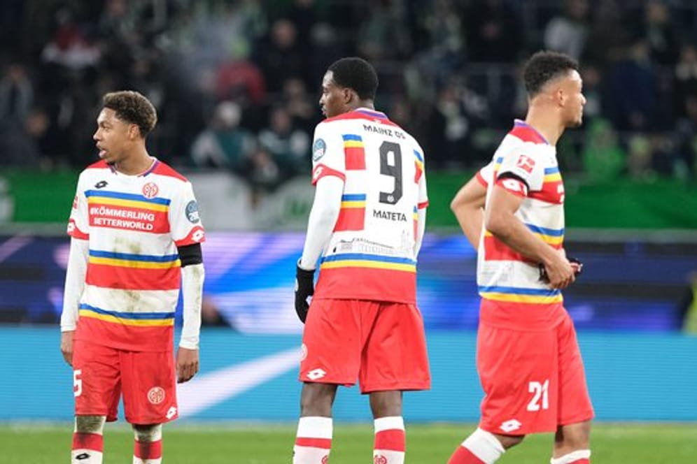 Getrübte Stimmung: Die Mainzer Jean-Paul Boetius (l-r), Jean-Philippe Mateta und Karim Onisiwo bleiben nach dem Schlusspfiff nach auf dem Spielfeld.