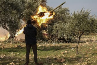 Ein Kämpfer der Nationalen Befreiungsfront sieht zu, wie während eines Großangriffs durch Oppositionsaktivisten auf syrische Regierungstruppen eine Rakete abgefeuert wird.