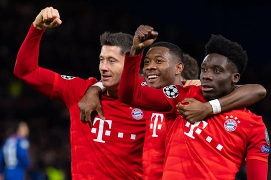 Torschütze Robert Lewandowski (l-r), David Alaba und Alphonso Davies jubeln über das 3:0 in London.