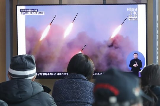 Menschen verfolgen in einem Bahnhof in Seoul eine Nachrichtensendung, die über einen Raketentest von Nordkorea berichtet.