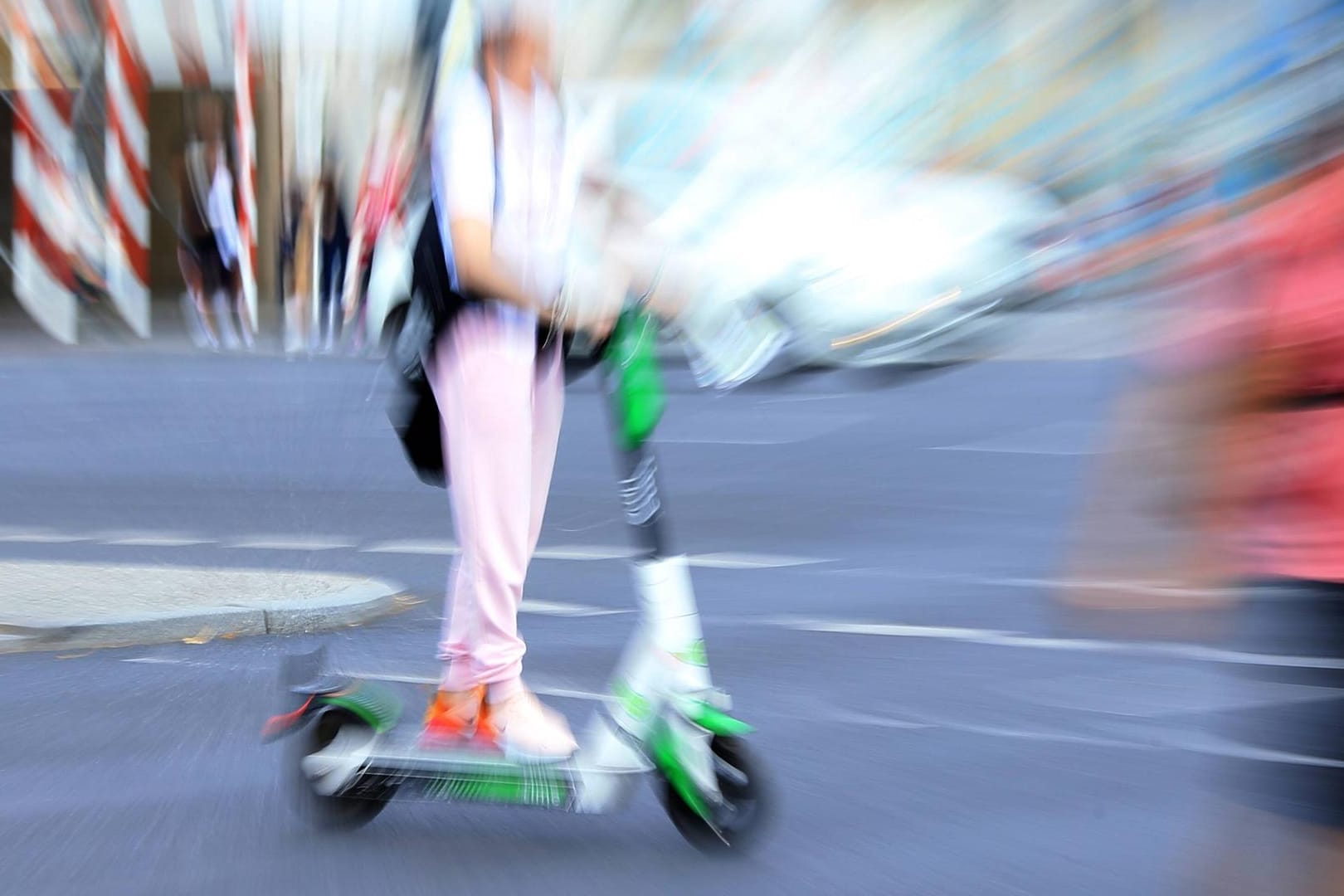 Ein E-Scooter-Fahrer fährt schnell zwischen Fußgängern (Symbolbild): Ein 33-jähriger Wolfsburger wurde betrunken auf einem E-Roller von der Polizei erwischt.