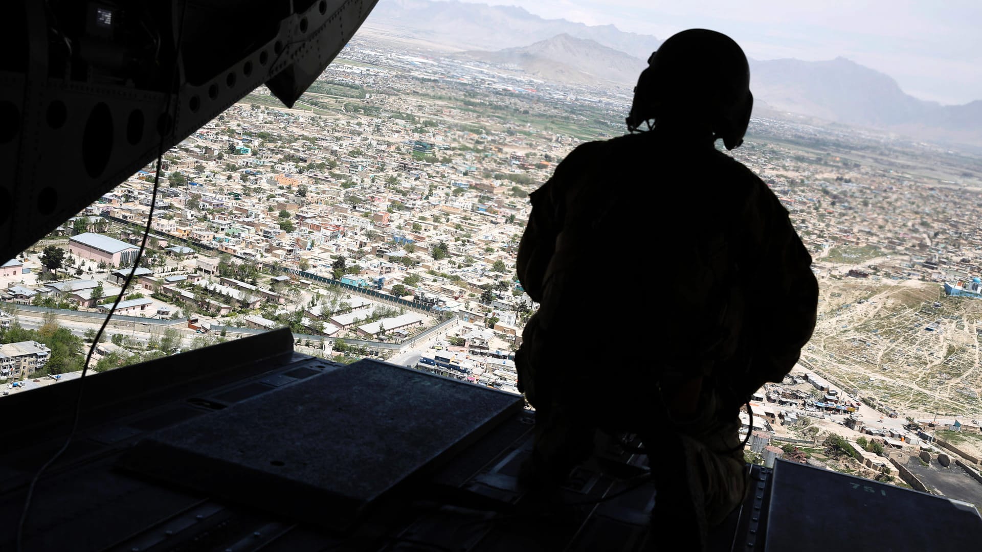 Ein US-Soldat an Bord eines Helikopters über Afghanistan: Die USA haben nach eigenen Angaben mit dem Truppenabzug begonnen.