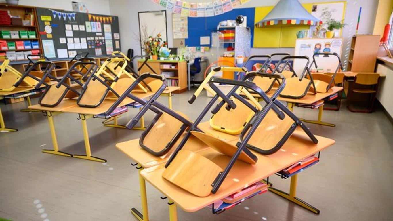 Stühle stehen in einer Grundschule in Stuttgart nach Ende der letzten Unterrichtsstunde auf den Tischen.