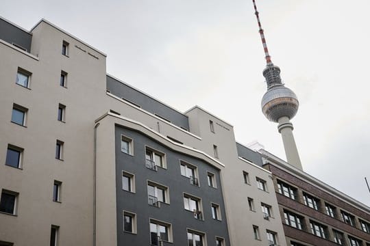 Der Fernsehturm steht hinter Häusern mit Mietwohnungen.