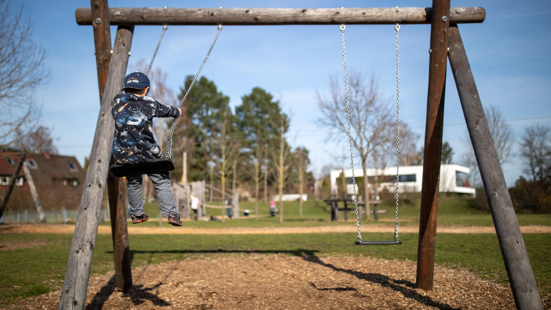 Ein Kind sitzt auf einer Schaukel auf einem Spielplatz in Nürnberg: Wegen des Coronavirus sind solche Plätze nunmehr geschlossen.