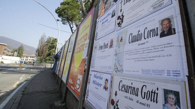 Todesanzeigen auf einer Tafel am Rand einer leeren Straße in Alzano Lombardo unweit von Bergamo. Todesanzeigen auf einer Tafel am Rand einer leeren Straße in Alzano Lombardo unweit von Bergamo.