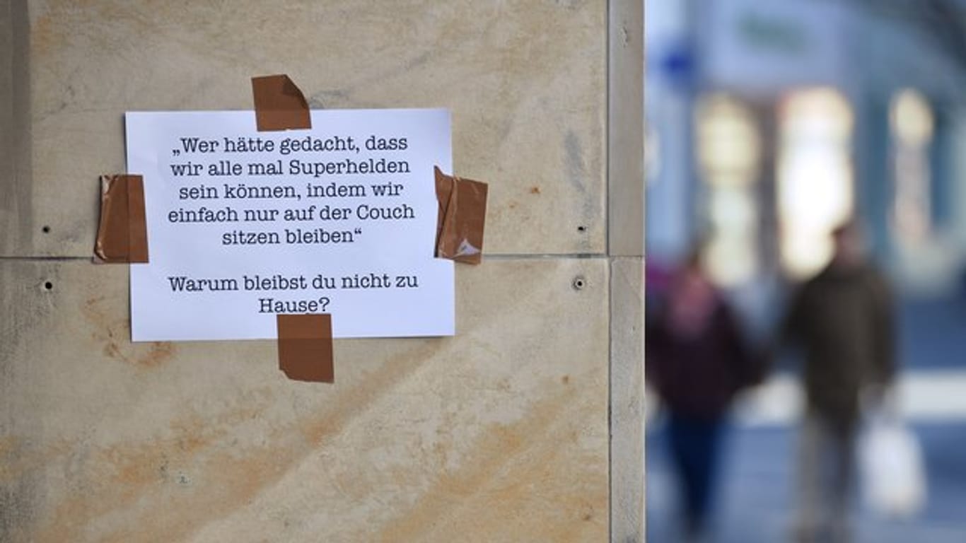 Botschaft auf einem Blatt Papier an einer Hauswand in Erfurt: "Warum bleibst Du nicht zu Hause?".