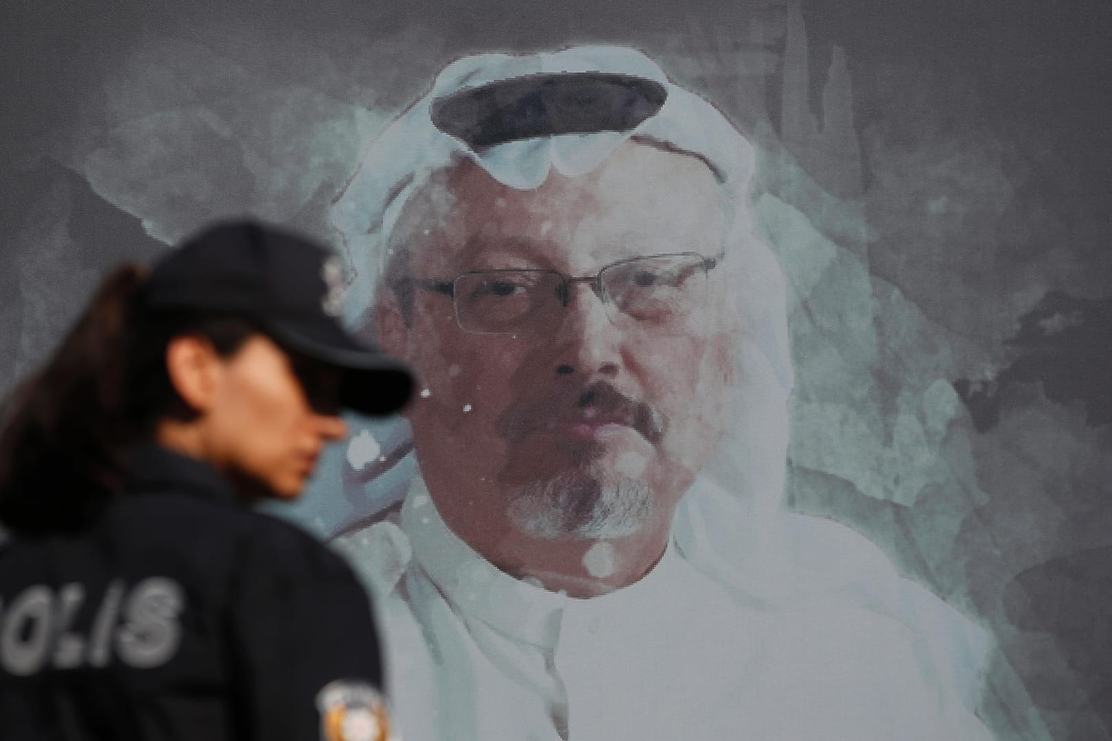 Eine Polizistin neben einem Wandbild des ermordeten Journalisten Jamal Khashoggi: Die türkische Staatsanwaltschaft hat Anklage gegen 20 Verdächtige im Mordfall Khashoggi erhoben.