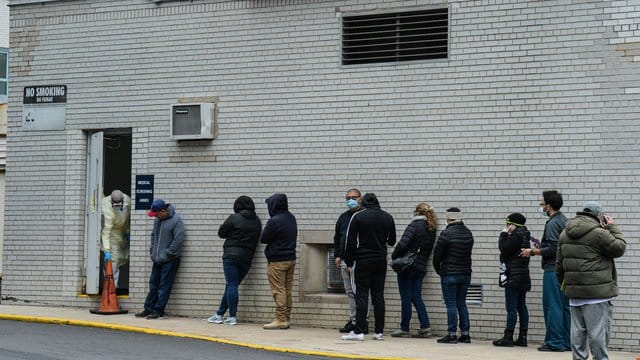 Menschen stehen vor einem Coronavirus-Testzentrum in New York Schlange. Menschen stehen vor einem Coronavirus-Testzentrum in New York Schlange.