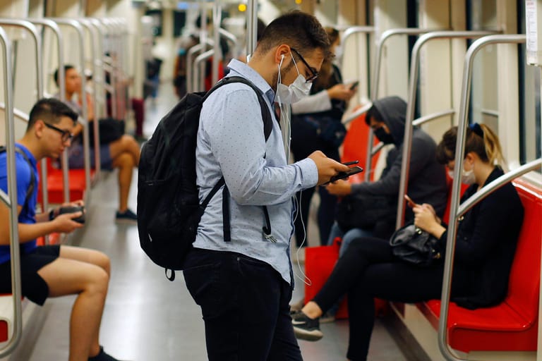 Ein Mann informiert sich in der U-Bahn auf dem Smartphone: Im Internet gibt es zum Coronavirus derzeit besonders viele Fake News und Verschwörungstheorien.
