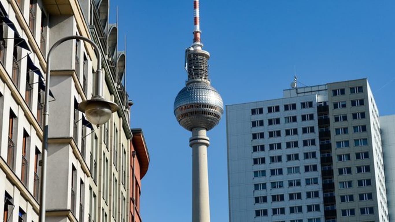 Der Fernsehturm ist zwischen sanierten Altbauten und einem Plattenbau-Hochhaus in Berlin zu sehen.