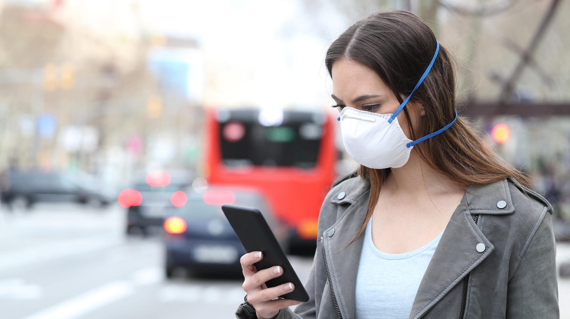 Eine Frau mit Smartphone und Maske: Derzeit wird nach einem Konzept für eine Corona-Warn-App gesucht. Eine Frau mit Smartphone und Maske: Derzeit wird nach einem Konzept für eine Corona-Warn-App gesucht.