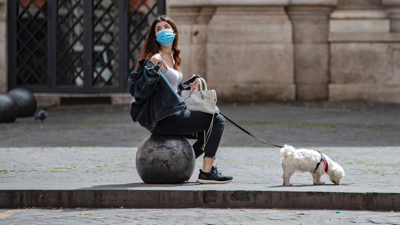 Eine Frau mit ihrem Hund in Rom: In vielen Ländern werden Corona-Maßnahmen vorsichtig gelockert. Ein Ende der Pandemie ist aber nicht in Sicht.