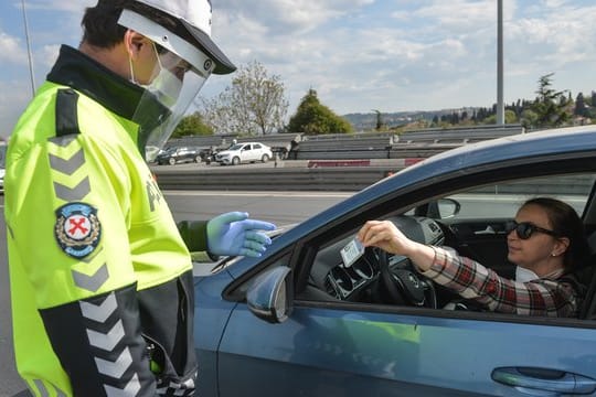 Ein Polizist kontrolliert in Istanbul eine Autofahrerin.