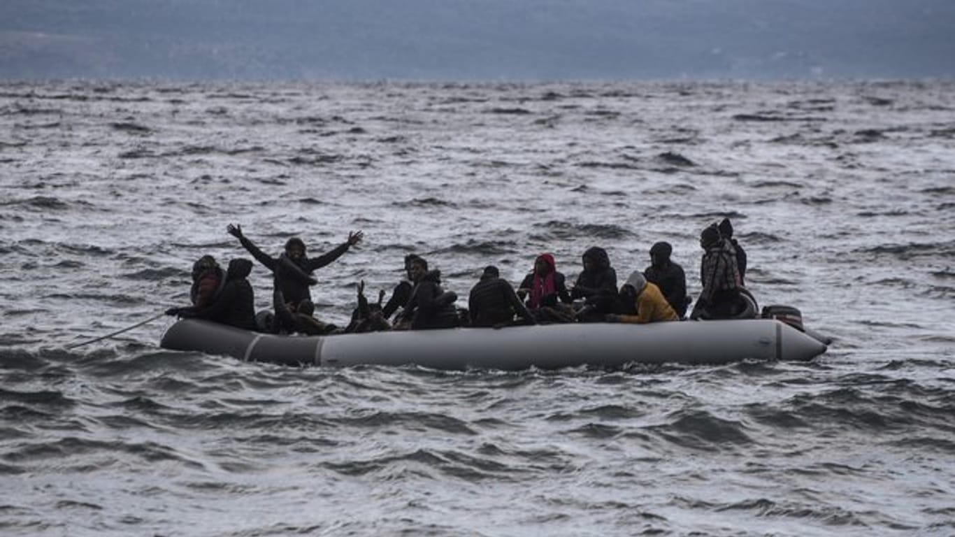 Vor der Küste Griechenlands winken Menschen in einem Schlauchboot um Hilfe.