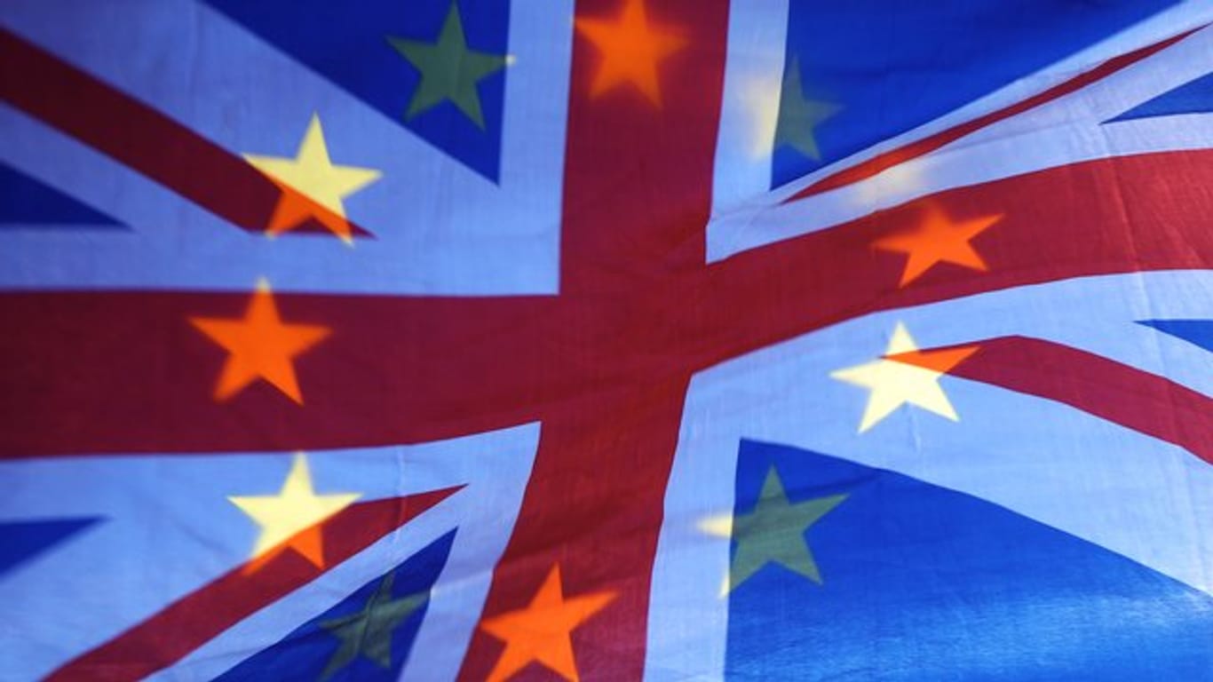 Die Sterne einer EU-Fahne scheinen durch eine britische Fahne hindurch.