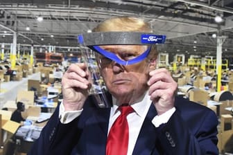 Donald Trump hält während des Rundgangs in einem Ford-Werk ein Gesichtsvisier in den Händen - einen Mundschutz trug er trotz Aufforderung nicht.