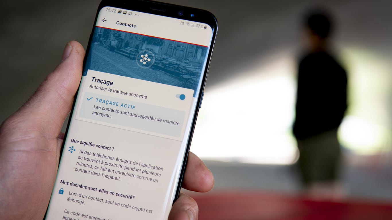 Ein Mann benutzt die Tracing-App SwissCovid auf seinem Smartphone: Eine ähnliche App zur Kontaktnachverfolgung soll es auch in Deutschland geben.