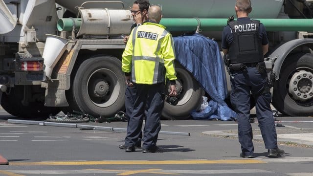 Eine blaue Plane hängt über einen Lkw-Reifen