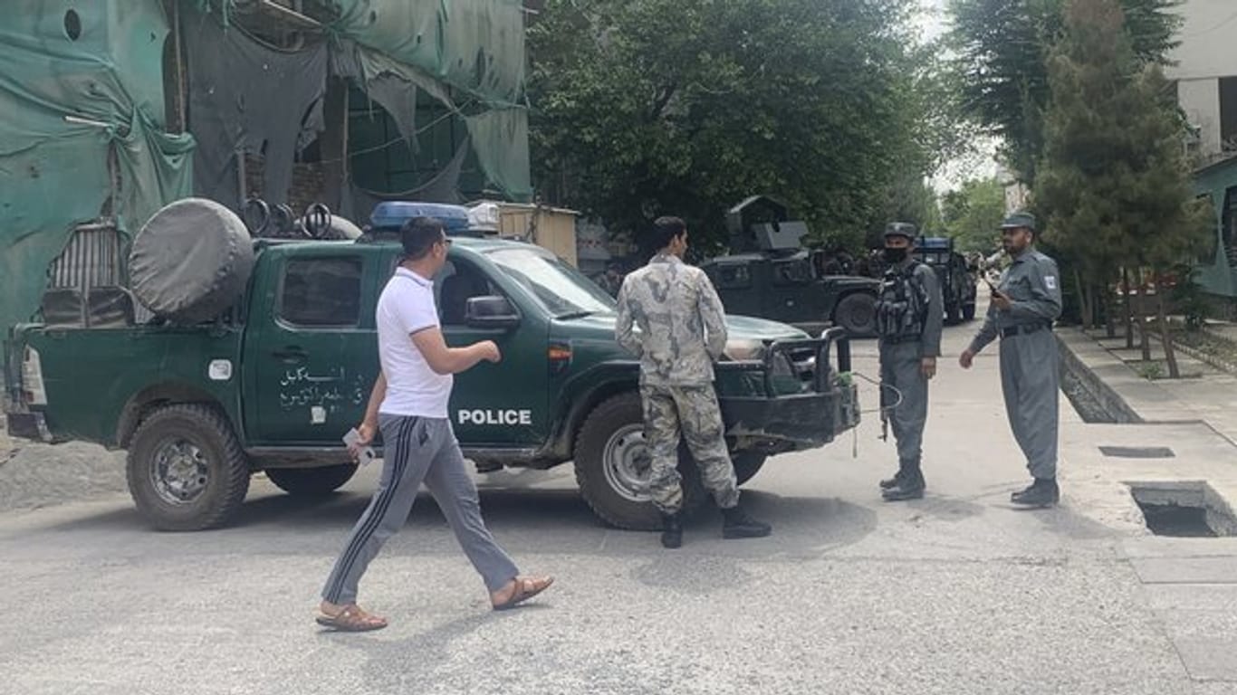 Polizisten sperren eine Straße in der Nähe des Anschlagsorts in Kabul ab.