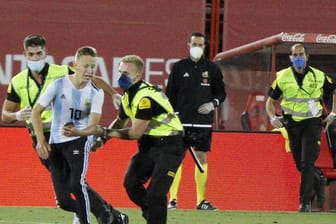 Der Flitzer wurde geschnappt, bevor er ein Foto mit Barcelonas Star Lionel Messi machen konnte.