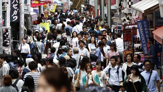 Menschen drängen sich auf einer Straße der japanischen Hauptstadt. Menschen drängen sich auf einer Straße der japanischen Hauptstadt.