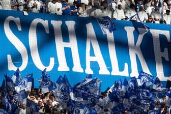 Schalke-Fans schwenken Fahnen: Der finanziell angeschlagene Bundesligaverein soll eine Bürgschaft von der NRW-Landesregierung erhalten.