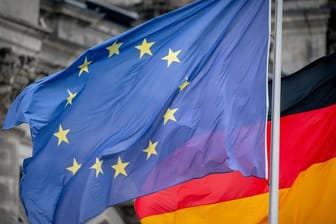 Die Deutschland- und die Europaflagge vor dem Reichstagsgebäude.