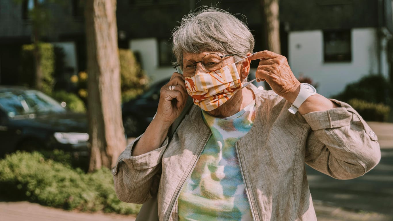 Eine Seniorin mit Gesichtsmaske (Symbolbild): Die Rentner in Deutschland erhalten ab Juli mehr Geld.