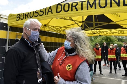 Beim Mitglied einer TV-Crew wird vor dem Einlass ins Stadion die Temperatur gemessen.
