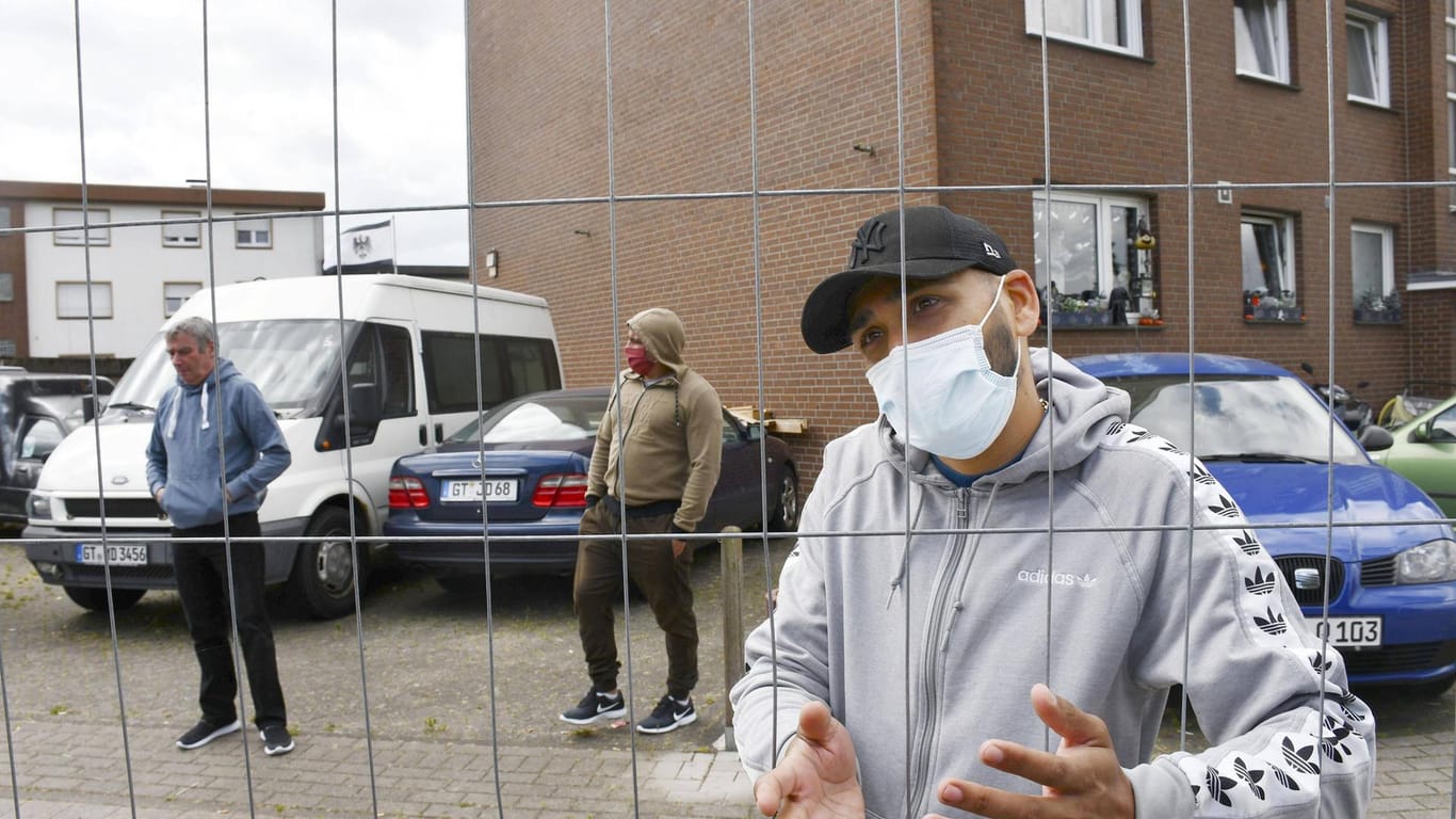 CORRECTED: Coronavirus infections rampant at German factory Employees working near Verl stand just outside an apartment