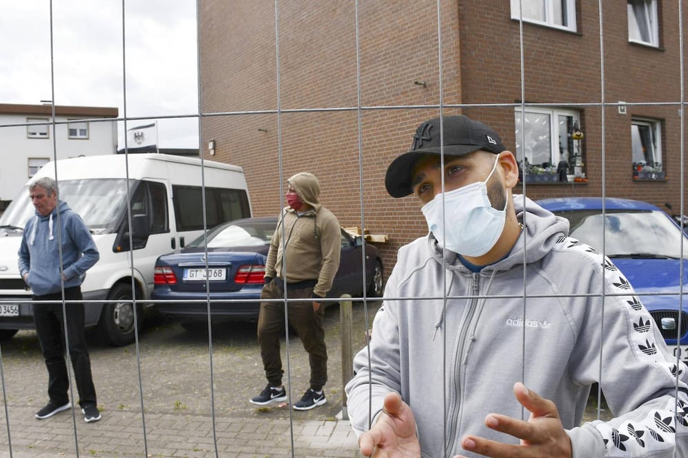 CORRECTED: Coronavirus infections rampant at German factory Employees working near Verl stand just outside an apartment