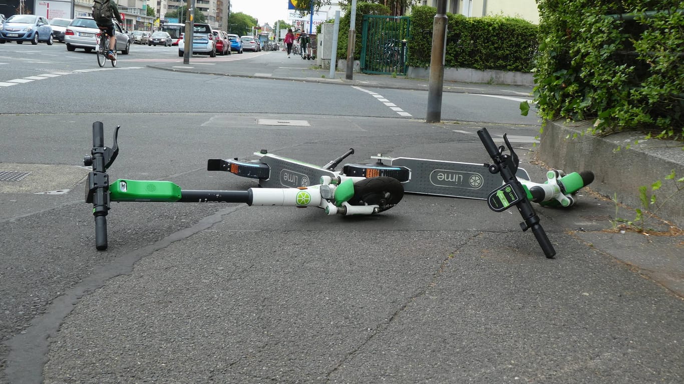 E Scooter der Firma Lime liegen auf einem Gehweg (Symbolbild): In Wolfsburg ist es zu zwei E-Scooter-Unfällen innerhalb weniger Stunden gekommen.